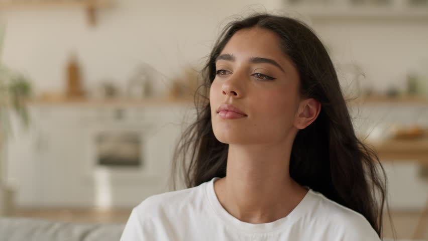 Indian woman Arabian girl Latina female lady close eyes at home enjoy cool fan blow hair fly enjoying conditioner air breeze blowing cooling temperature climate control system house apartment refresh