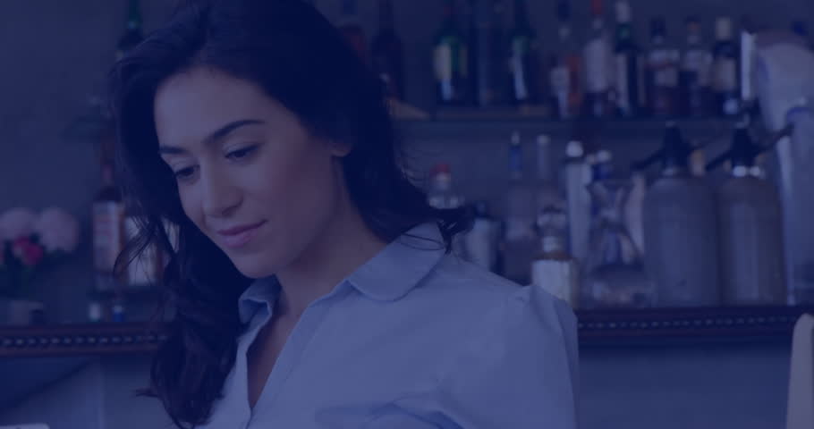 Animation of media icons over biracial businesswoman using tablet. Business, technology and digital interface concept, digitally generated video.