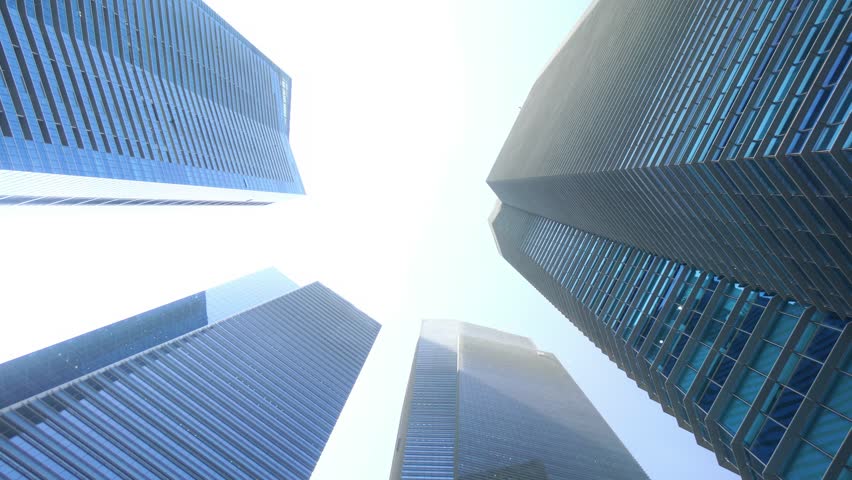 Singapore time lapse 4K, city skyline timelapse looking up under skyscraper building business district