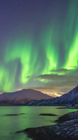 Tromso Norway time lapse of the aurora borealis northern lights winter landscape at Rorvikneset Sommaroy (Vertical)