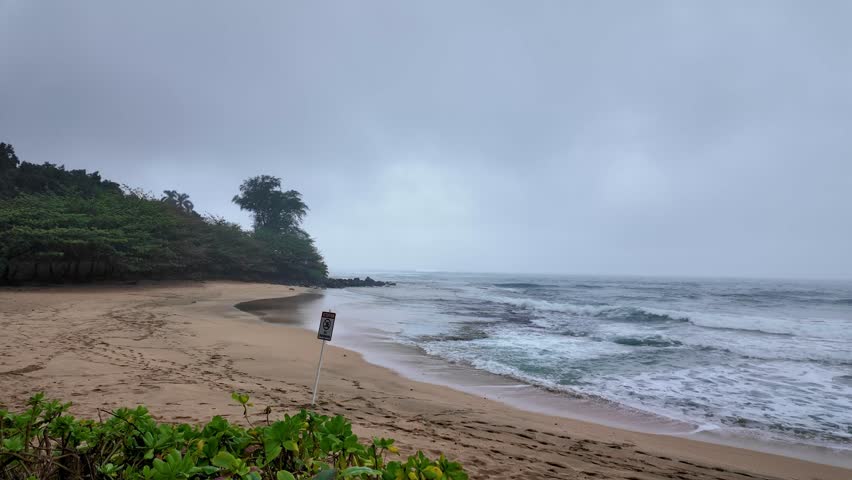 A beautiful sandy Haena Beach at Haena Beach Park on North Shore of Kauai, Hawaii. Small, picturesque sand beach with occasional strong surf. It has a lifeguard station, restrooms, showers, campsites