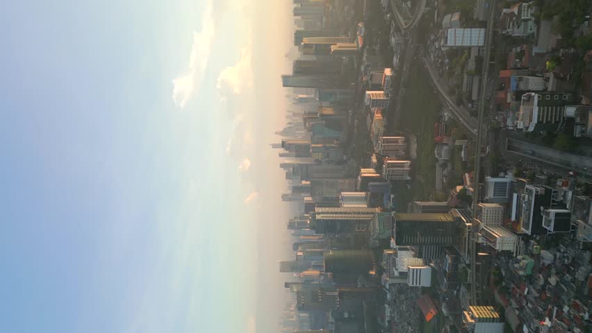 Vertical video. Aerial view of Jakarta city skyline at dawn, Indonesia