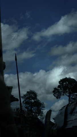 An Impressive Medieval Knight Dressed in Full Armor Standing Strong Against a Dramatic Sky