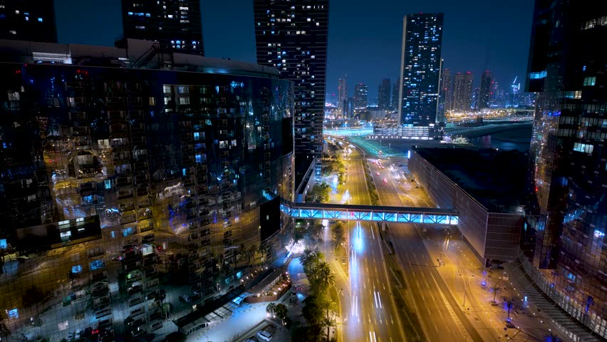 Night vehicle traffic on Al Reem Island in Abu Dhabi at night - panning motion hyper lapse
