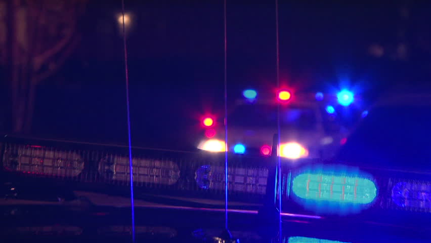 PORTLAND OREGON, CIRCA 2013: Police lights flashing at night downtown at crime