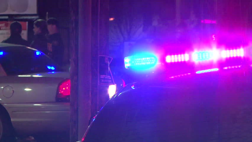 PORTLAND OREGON, CIRCA 2013: Police lights flashing at night downtown at crime