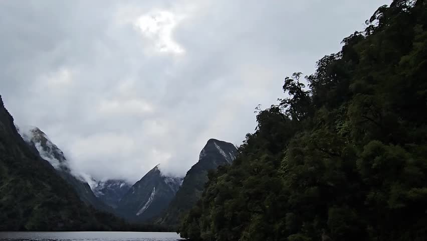 view to the cloudy mountains of the Doubtful Sound in Fiordland, south west of New Zealand