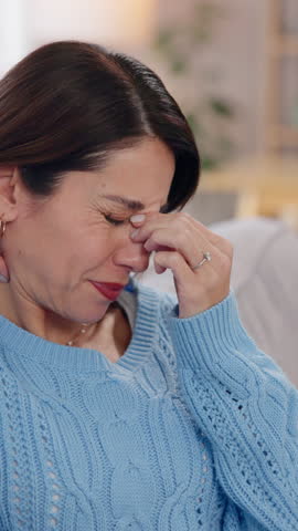 Woman, anxiety or face in home with headache, pain or burnout with discomfort. Mature person, stress or vertigo in lounge with health crisis, sinus congestion or tired with temple massage for relief
