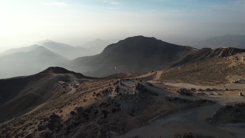 Tourists at a Lookout Point Known as “Apu Siqay” in Villa Maria del Triunfo, with a Brand New Peruvian Flag at the Sunset