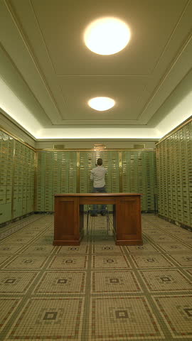 An Elegant Vault Interior featuring Green Lockers along with a Central Table for functionality