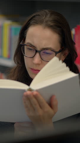 Focused reading in a tranquil library offers opportunities for academic growth and reflection