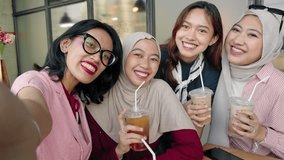 Asian girl friends friends sitting in cafe take a selfie with cell phone camera - Powered by Shutterstock - Get 15% off with code: PIKWIZARD15