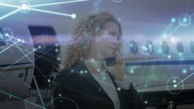 Animation of network of connections caucasian businesswoman with smartphone by plane. Global travel, finance, business, connections, computing and data processing concept digitally generated video. - Powered by Shutterstock - Get 15% off with code: PIKWIZARD15