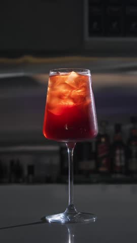 Final stage of preparing a refreshing summer cocktail, typical of Northern Italy. Close up. Slow motion. Vertical