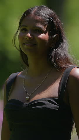 A young woman is singing joyfully in the beautiful and serene nature around her