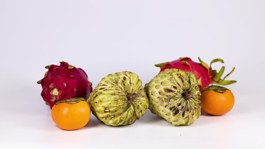 Hands interact with fruits on a table
