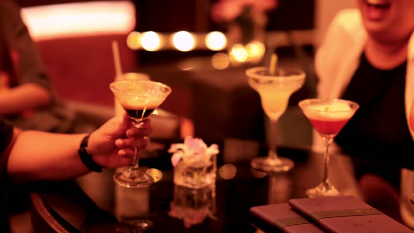 Friends enjoying cocktails in a cozy lounge