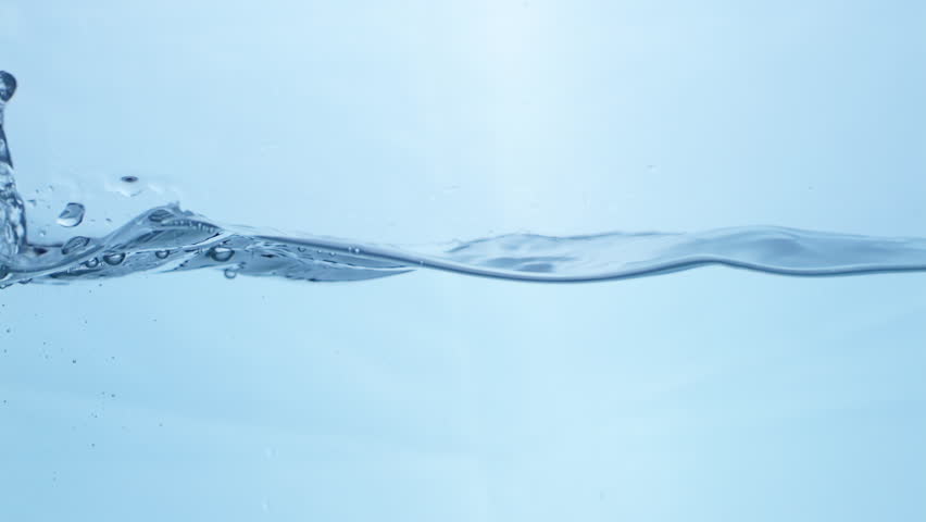 Translucent blue waves in slow motion, illustrating the purity and refreshing characteristics of natural water sources.