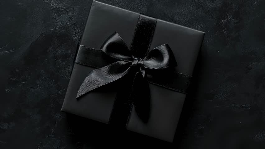 Elegant Black Gift Box With Ribbon on Dark Background