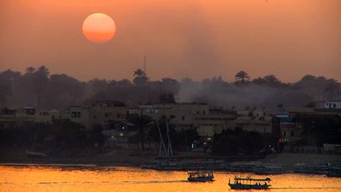 View of Nile river at sunset with Felucca traditional sailboats near Luxor in Egypt 