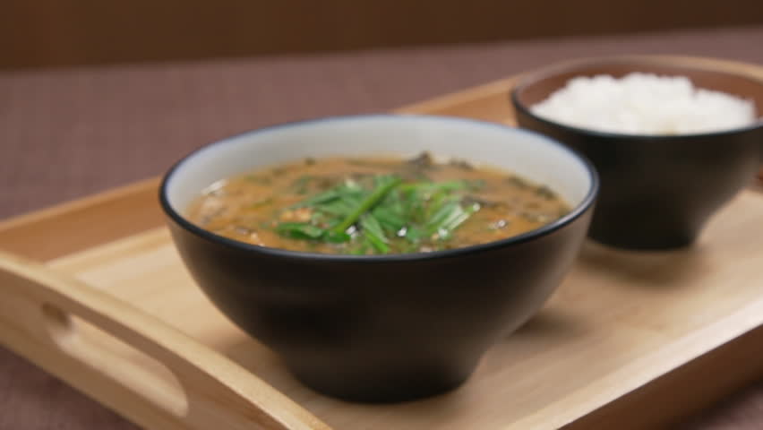 Bowl of hot chueotang and rice on a wooden tray