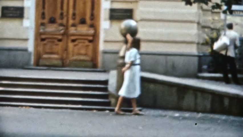 Relaxed woman enjoying walk through historic city center, looking at architecture beauty. Tourism in historical cities. Happy, relaxing city life in summer. Vintage film. Travel archive. Retro 1980s