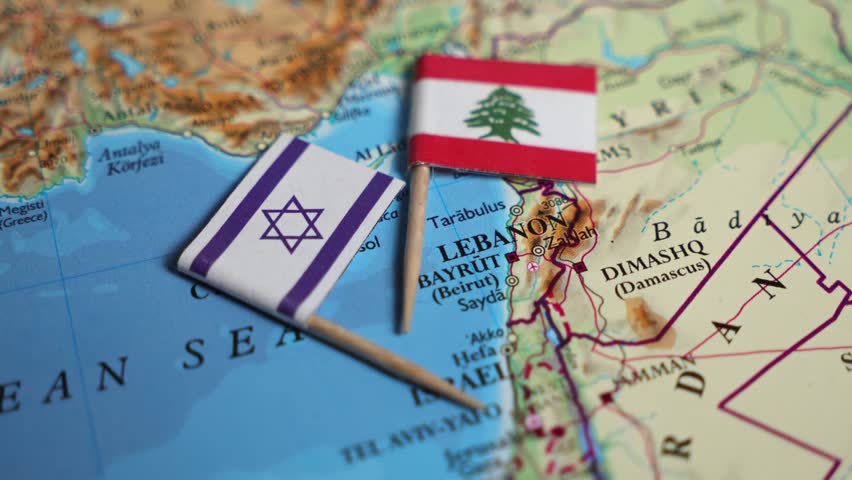 Close-up of the flag of Israel and the flag of Lebanon on a map with the capitals of the two powers.
