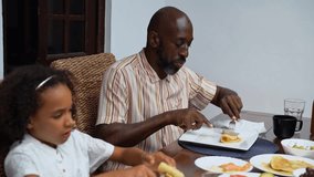 Happy diverse parents and children African-American Caucasian eating weekend lunch breakfast together. Family tradition, healthy food for children, leisure activity, care and relationships - Powered by Shutterstock - Get 15% off with code: PIKWIZARD15