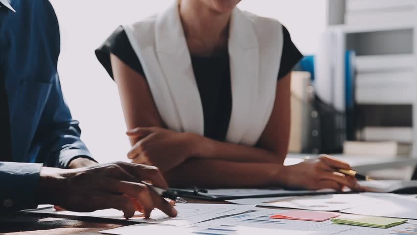 Business Team Presentation with Investors, Consulting on Strategic Plans for Market Growth. Corporate Meeting Focused on Analyzing Financial Documents and Graph Reports for Business Development