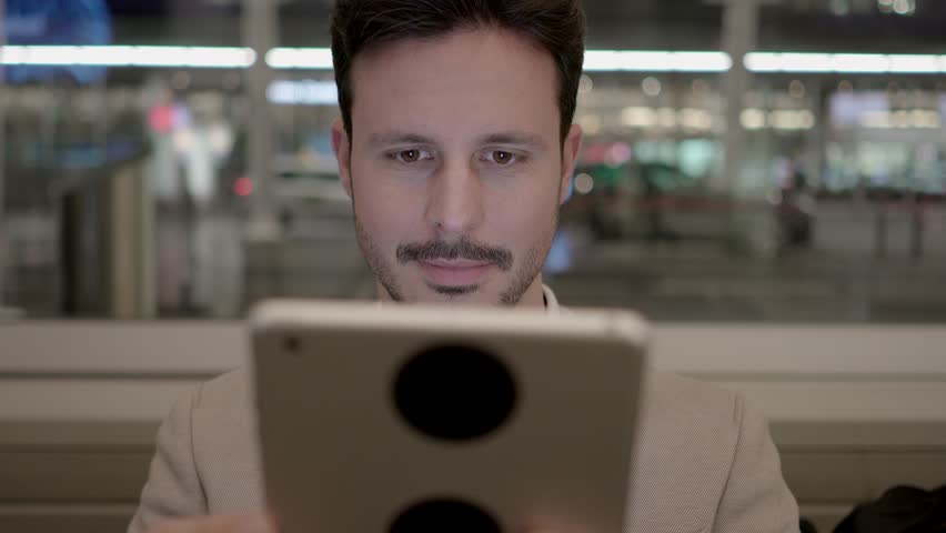 Man is Seen Tapping and Swiping on the Tablet Screen