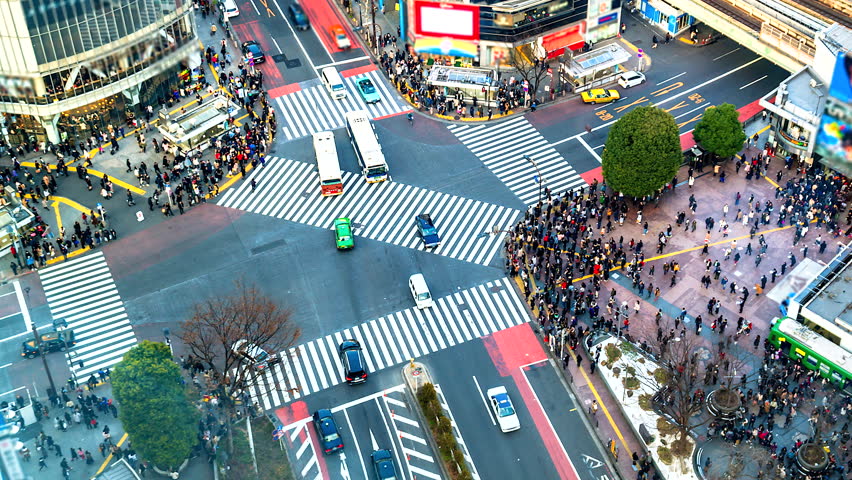 Time lapse people crossing the street and cars at Shibuya intersection in the heart of Tokyo, Japan, Asia