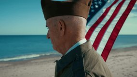 United States Navy Veteran Is Moved Looking At The Ocean With American Flag - Powered by Shutterstock - Get 15% off with code: PIKWIZARD15