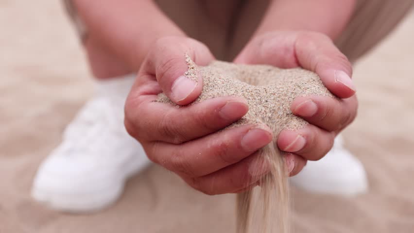 The flowing sand that can't hold it slip away from the fingertips