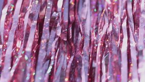 Shimmering Pink Tinsel Decorations for Celebrations and Events. Sparkling pink tinsel sways gently, festive summer background - Powered by Shutterstock - Get 15% off with code: PIKWIZARD15