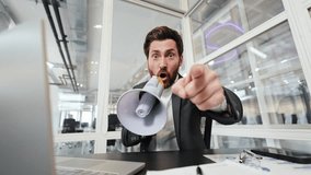 Angry businessman yelling through megaphone in office. Furious boss with megaphone shouts at subordinates. Stress, deadline, burnout. Office worker yells at employees with megaphone. - Powered by Shutterstock - Get 15% off with code: PIKWIZARD15