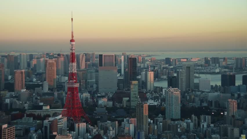 Cityscape of Tokyo at sunset, as seen from the top of one of the highest buildings in Roppongi Hills. cbd with Tokyo tower. Endless cityscape with a orange evening sky. Tokyo city view