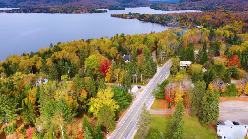 A stunning drone shot of Ottawa, Ontario, follows the winding river with views of vibrant autumn trees and scenic hills. This aerial footage captures the essence of Canadian nature in fall.
