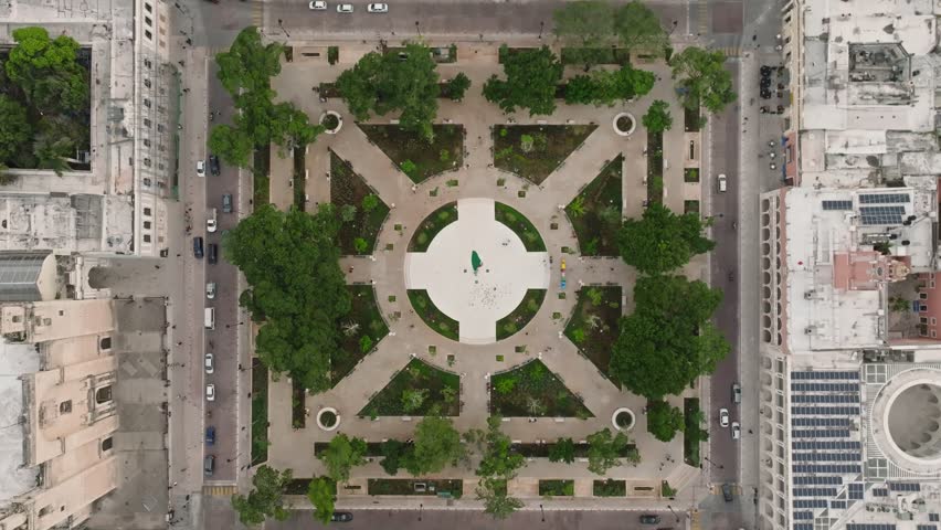 Aerial view of vibrant Merida Plaza with bustling streets, greenery, and historic buildings, Merida, Yucatan, Mexico.