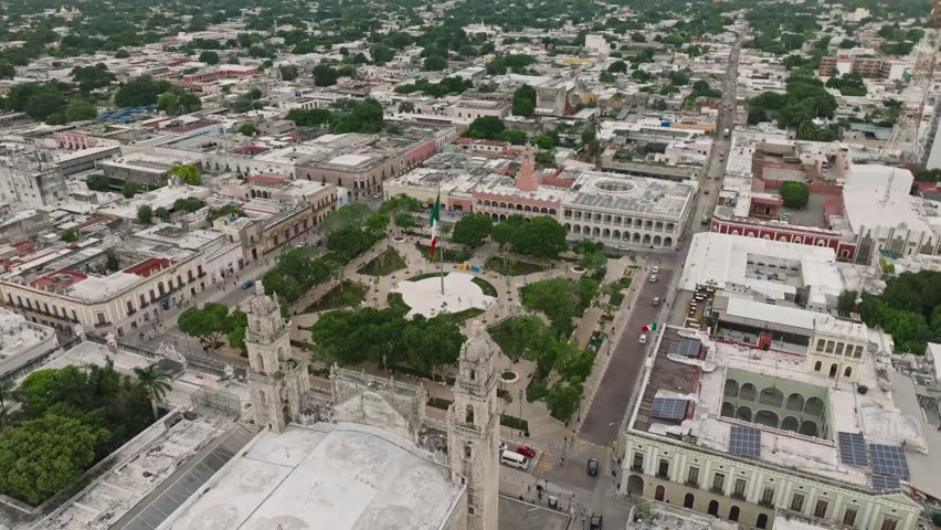 Aerial view of vibrant Merida Plaza with historic cathedral and lush greenery, Merida, Mexico.