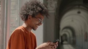 African American ethnic guy male man student using mobile phone in college university high school scrolling smartphone smiling happy e-commerce social media addict study education break gadget online - Powered by Shutterstock - Get 15% off with code: PIKWIZARD15