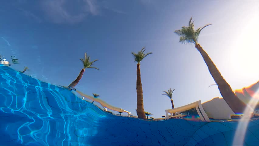 Clear water surface glistening in the sun on a sunny day in Egypt, slow motion. Water in the pool. Beautiful water background.