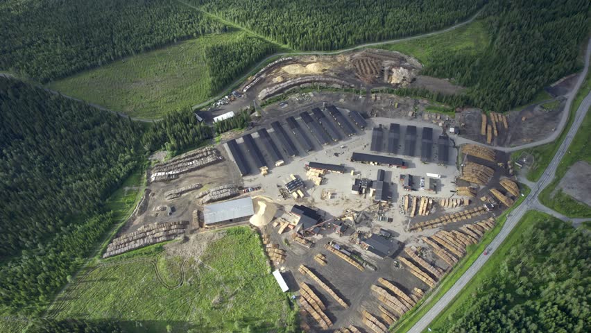 Aerial view of a wood factory amidst deforestation and logging activities, Haxas, Sweden.