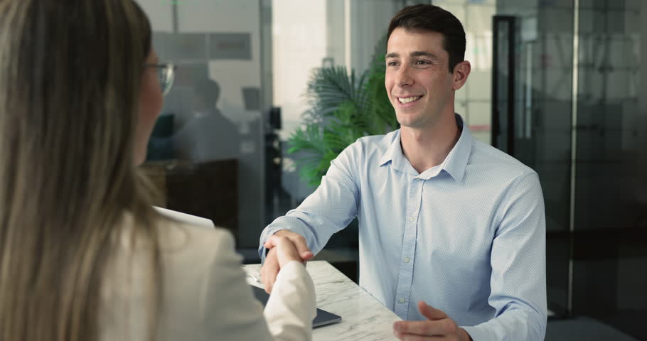 HR manager congratulating female applicant with successful hiring, met in company office, shaking hands, finish formal renegotiations event or staffing process. Boss and client establish commitment