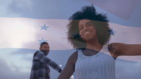 Animation of flag of honduras over happy diverse couple dancing with sparklers on beach at dusk. Summer, romance, freedom, celebration, vacations, patriotism and travel, digitally generated video. - Powered by Shutterstock - Get 15% off with code: PIKWIZARD15