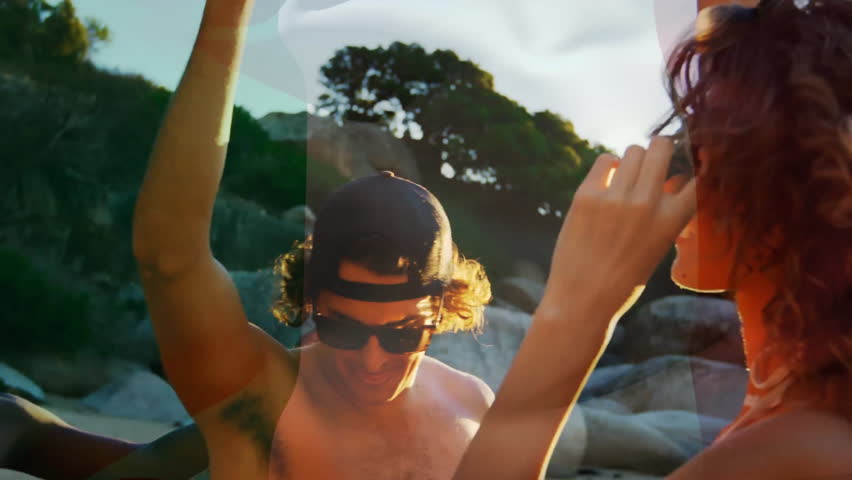 Animation of flag of italy over happy diverse friends drinking and dancing on sunny beach. Italian, summer, friendship, freedom, vacations, party, travel and patriotism, digitally generated video.