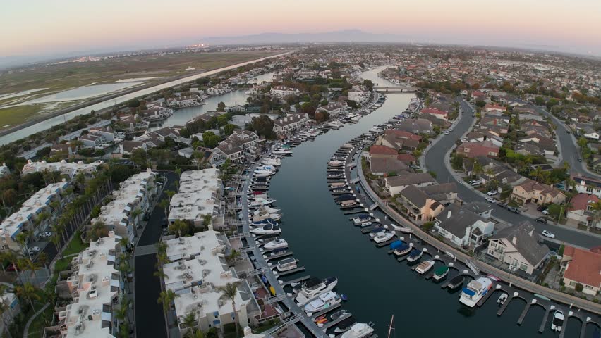 An aerial footage of the Huntington Harbour community at sunset in the northwestern section of Huntington Beach in Orange County, California, USA