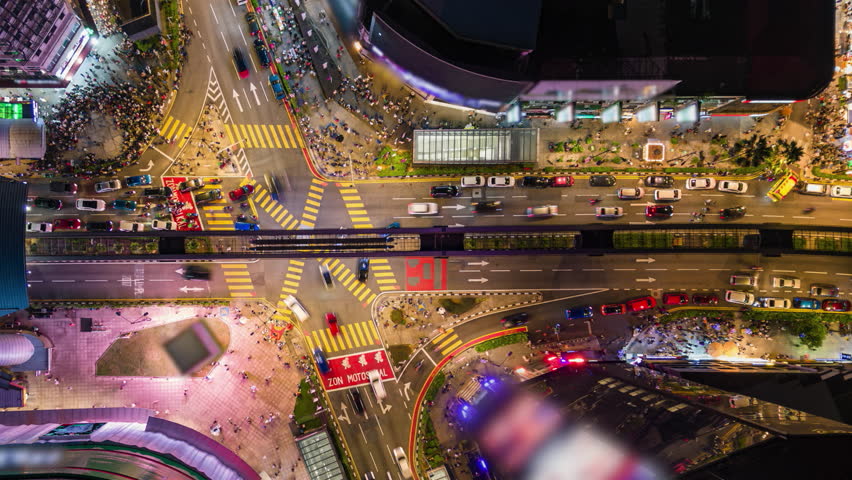 Aerial timelapse of evening traffic at Bukit Bintang intersection in downtown Kuala Lumpur, Malaysia