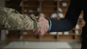 Close up male handshaking. Two unrecognizable men military soldier veteran warrior guy veteran officer grabbing arms shaking hands businessman entrepreneur gratitude respect greeting handshake indoors - Powered by Shutterstock - Get 15% off with code: PIKWIZARD15