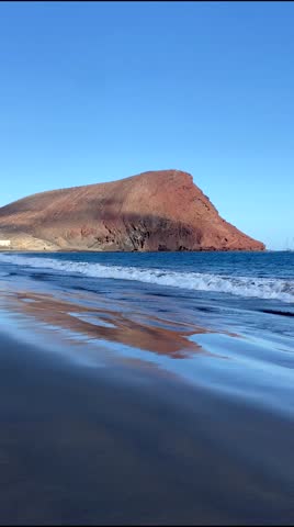 Beautiful view of La Tejita beach with Red Mountain.Montana Roja and Playa de la Tejita in El Medano, Tenerife, Canary Islands, Spain,4k