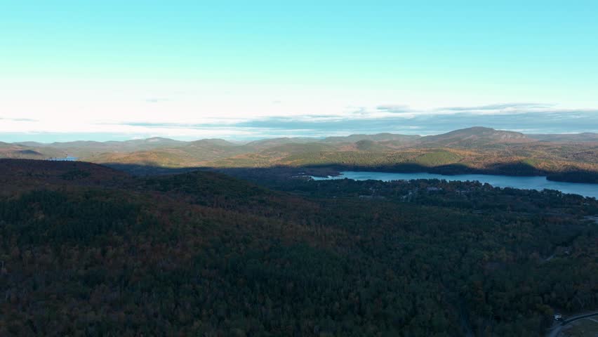 Timelapse capturing the movement of shadows over the mountains and forests as the sun sets over Schroon Lake, New York, with the fading light creating a serene, dynamic landscape.